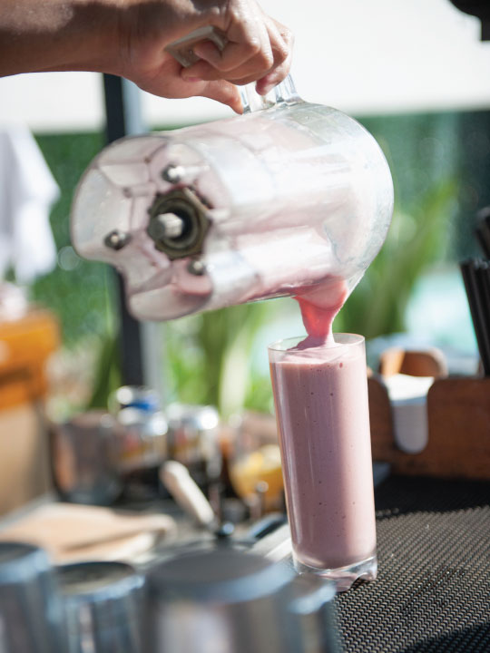 Pouring a smoothie from a blender